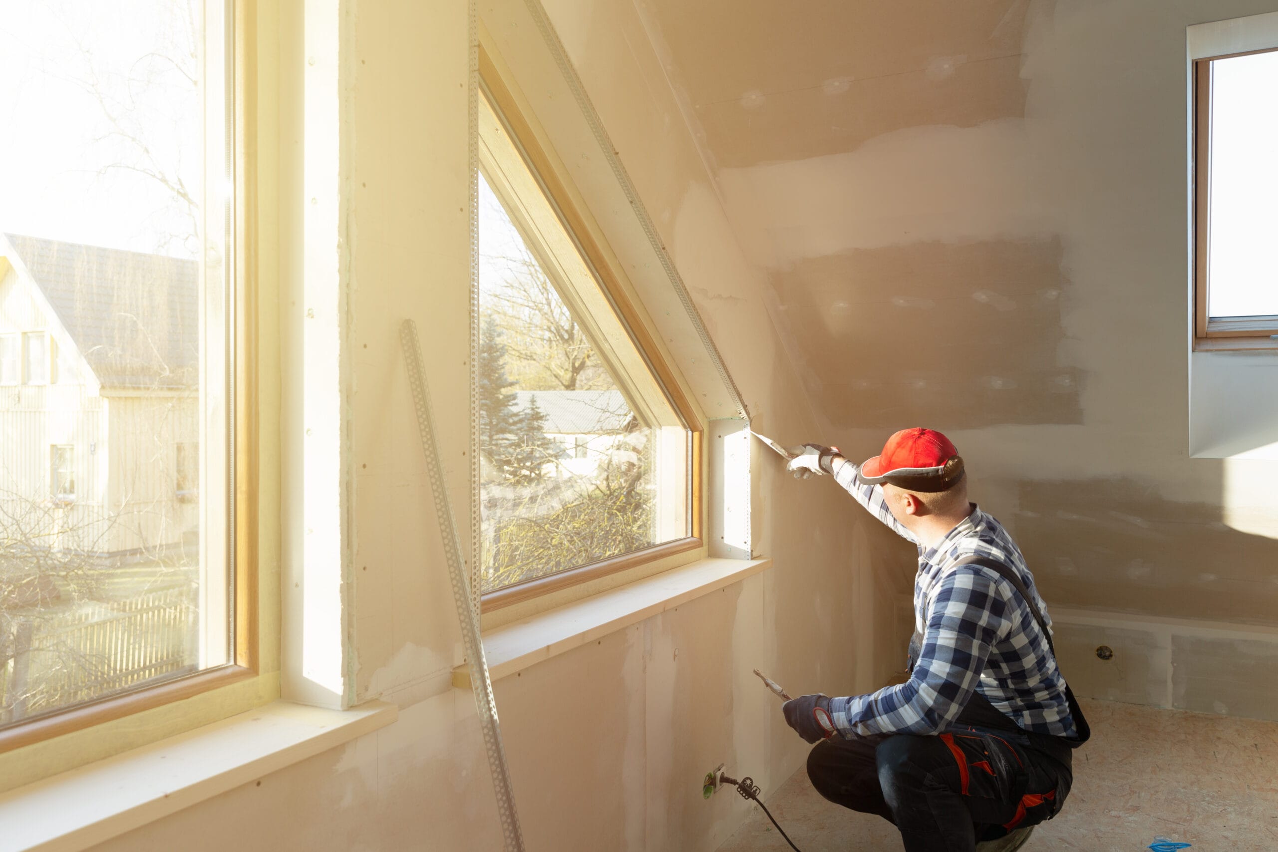 home-improvement-handyman-filling-drywall-with-filler-in-new-build-attic-stockpack-adobe-stock home improvement handyman filling drywall with filler in new build attic