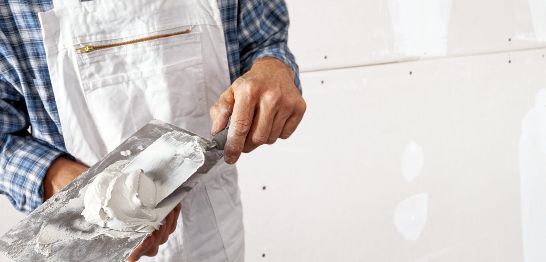 drywall-installation-filling-the-joints-of-plaster-boards-stockpack-adobe-stock Drywall installation, filling the joints of plaster boards